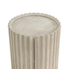 High-angle close-up focusing on the recessed circular top and the scalloped edges of the vertical ribbing