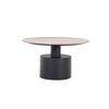 Front view of the Ocean coffee table featuring a circular beige travertine top supported by a substantial black metal pedestal base