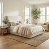 Oceana king bed in beige upholstery styled in a bright modern bedroom with neutral bedding and natural decor.