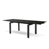 Perspective view of the Odd dining table featuring a Shakespeare Black porcelain top with subtle white veining and architectural black steel legs