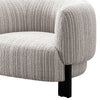 Side view of Odin upholstered accent chair with curved armrest