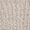 Full-frame macro shot of the off-white bouclé fabric for material and texture reference