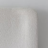 Straight-on detail shot showcasing the seamless upholstery and the uniform texture of the off-white fabric
