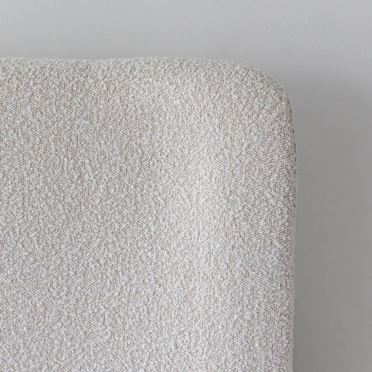 Front view of the Aino queen platform bed featuring a tall curved wingback headboard and off-white bouclé upholstery