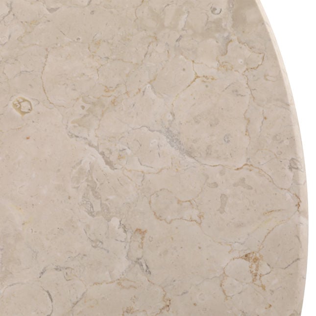 Macro detail view of the cream-colored stone tabletop showcasing its organic pitted texture and smooth finish