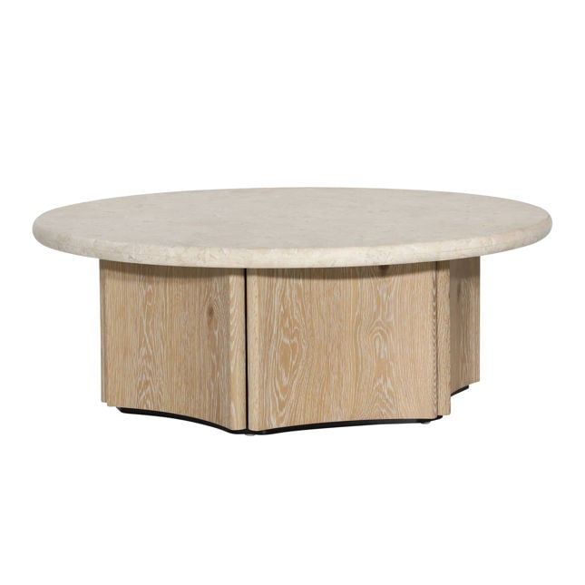 Three-quarter perspective highlighting the low profile and thick stone surface of the Oja round coffee table