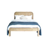Straight-on studio view of the bed styled with pillows and a white duvet highlighting the integrated slat system