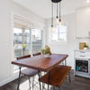 Perspective view of the Organic bench paired with a matching live-edge dining table in a contemporary home setting