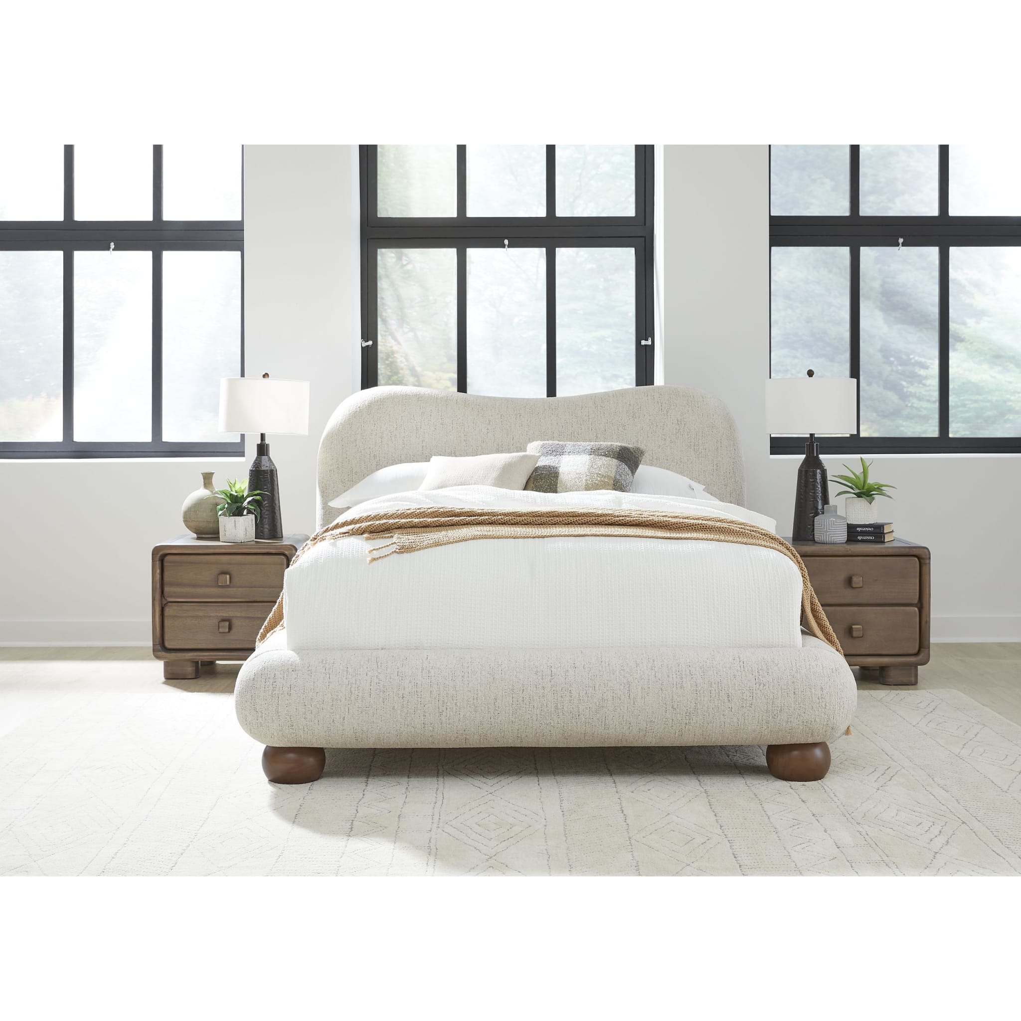 Front view of the Afra upholstered bed featuring a soft cream chenille fabric and a modern wave-shaped rounded headboard