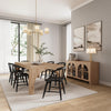 Lifestyle shot featuring the Archimedes console styled in a bright organic modern dining area with a matching wood table and black chairs