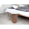 Lifestyle shot of the Abelone marble side table used as a nightstand in a contemporary bedroom setting