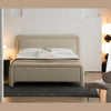 Lifestyle shot featuring the Alba bed styled with neutral linens and a dark wood nightstand in a bright contemporary room