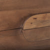 Macro shot focusing on the tactile rounded wooden drawer pulls and the natural grain of the walnut veneer
