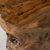 Perspective shot focusing on the hand-carved details and natural hollows found within the solid teak root base