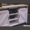 Lifestyle shot focusing on the open central shelves organized with dark ceramic dishware and neutral decor