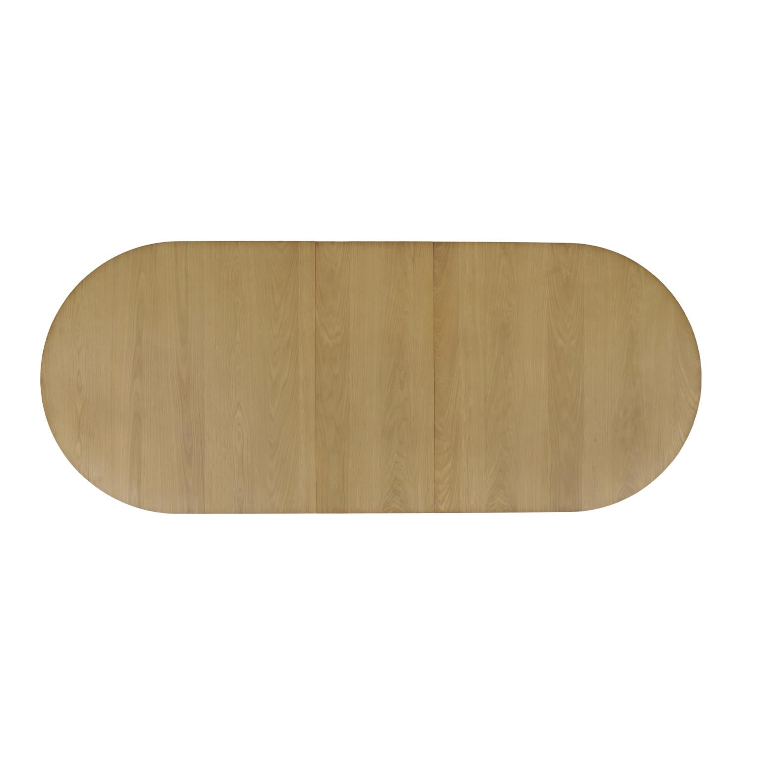 Front view of the Nord dining table in a natural oak finish featuring an oval tabletop and two thick fluted pedestal bases