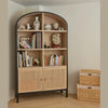 Interior styling view showing the cabinet paired with natural woven baskets in a warm residential setting