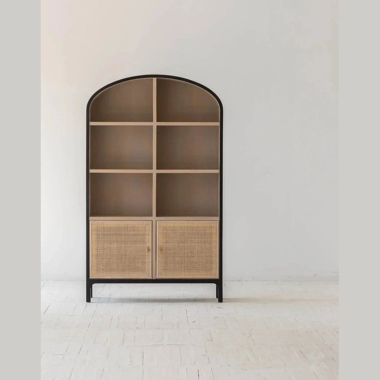Straight-on front view showcasing the symmetrical six-compartment open shelving and lower cane-front storage