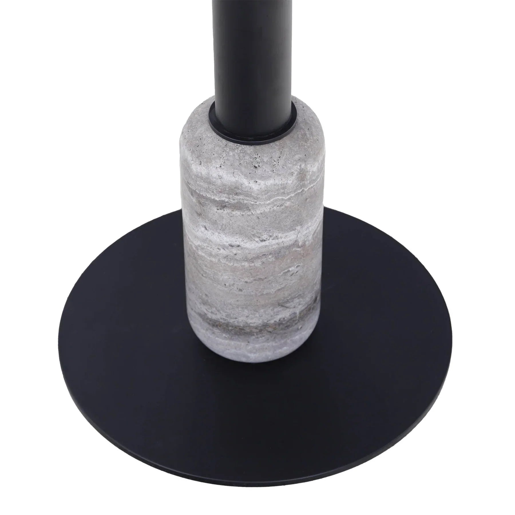 Detail shot focusing on the cylindrical travertine stone accent at the bottom of the black metal pedestal and the flat circular base