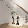 Lifestyle perspective showing the table as a functional accent piece positioned between two modern armchairs