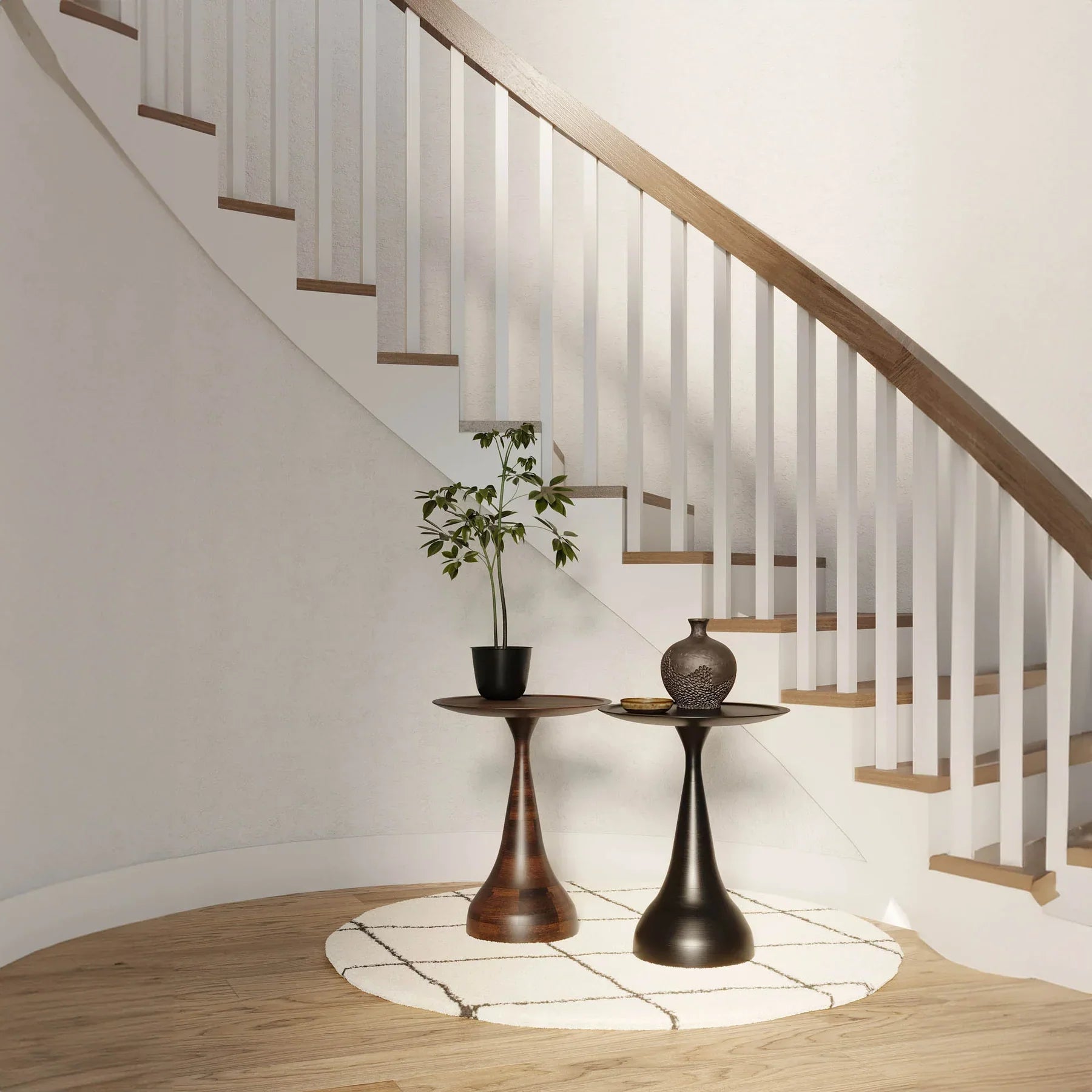 Three-quarter view of the Polina side table featuring a circular white marble top and a sculptural bronze-finished circular pedestal base