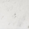 Macro shot of the white marble surface highlighting the subtle grey mineral veining and polished finish
