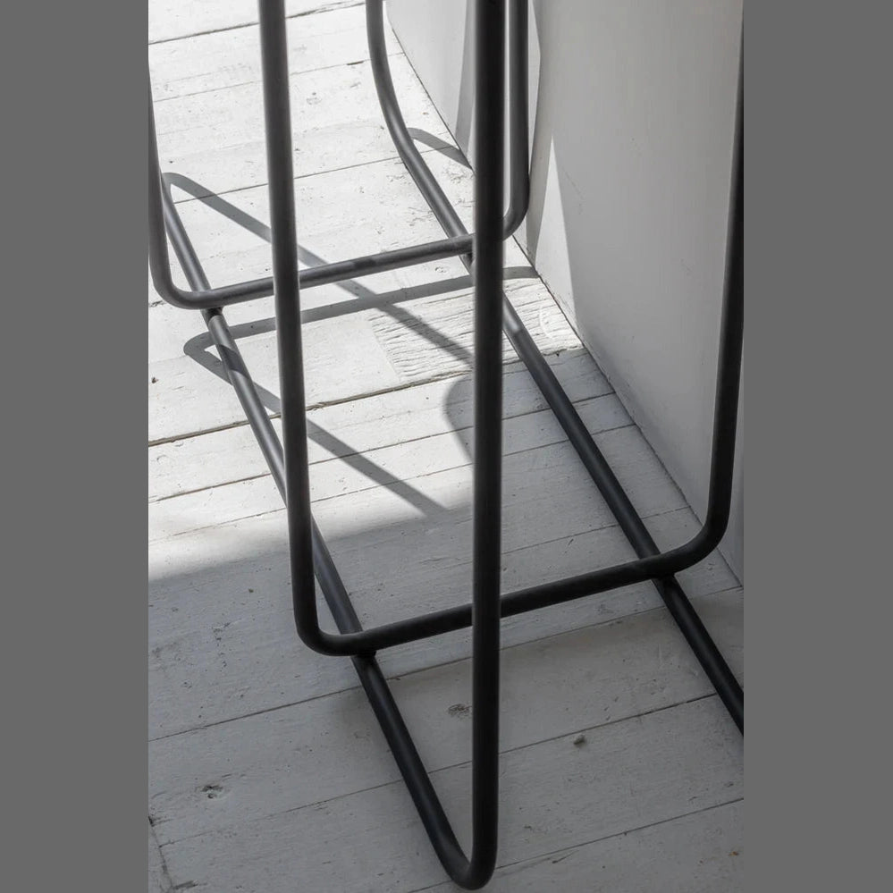 Low-angle perspective view highlighting the structural depth and rhythmic lines of the black metal support frame