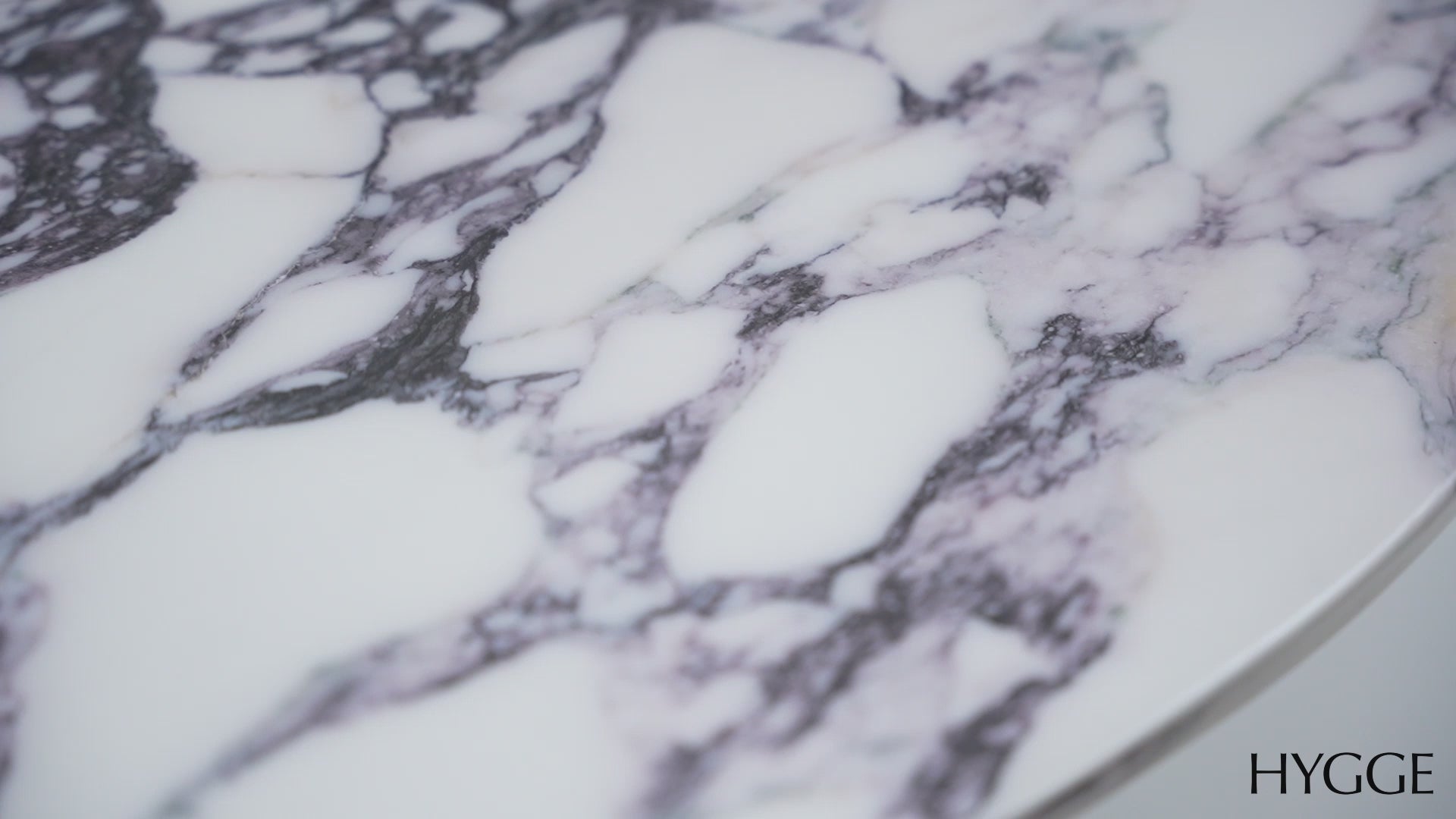Detailed overhead view highlighting the realistic purple marble pattern and high-shine finish of the circular table