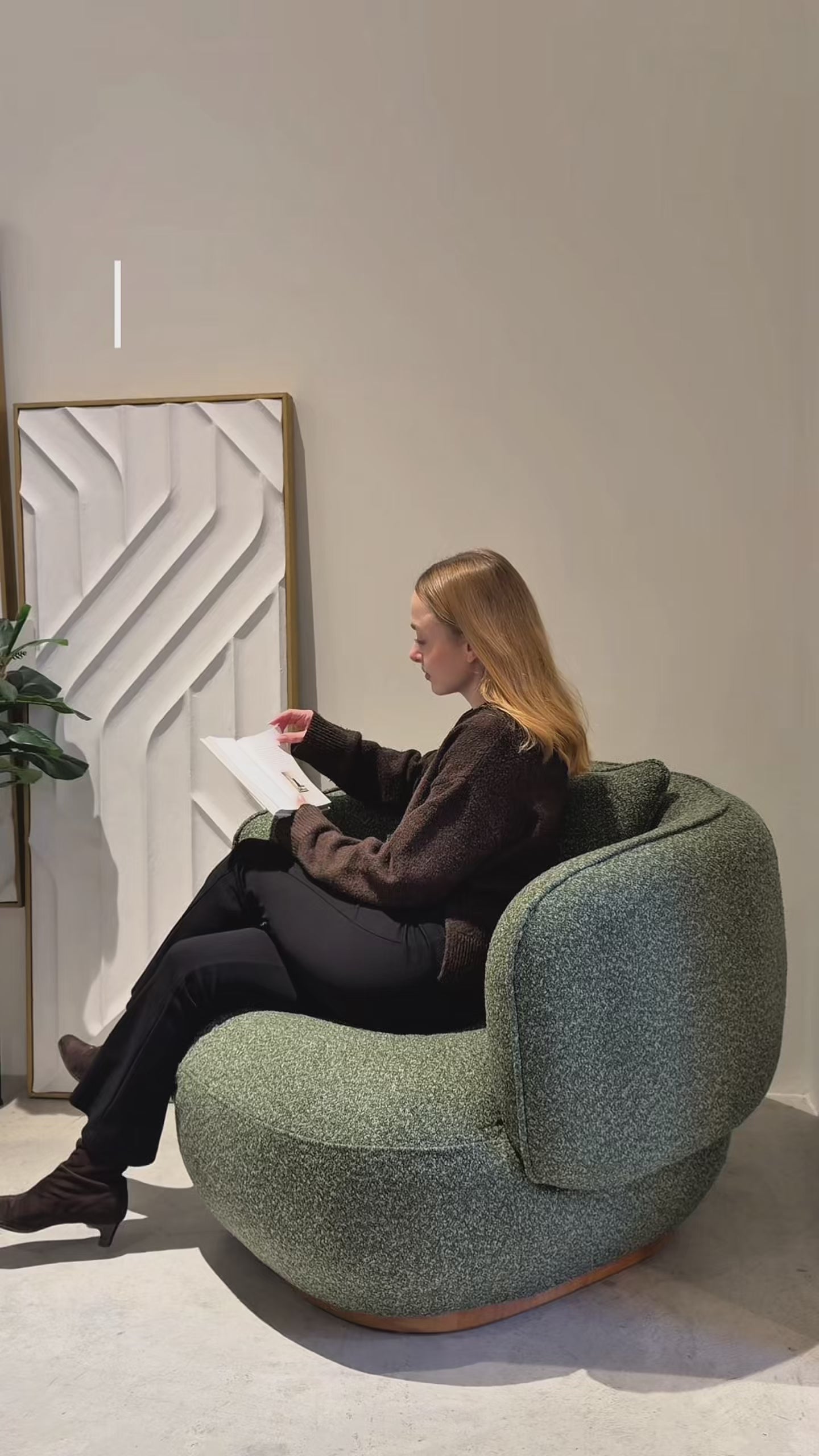 Lifestyle perspective from video showing the Luna chair in a contemporary living room setting highlighting its 360-degree swivel