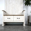Low-angled front view focusing on the two storage drawers with dark metal hardware and the sturdy plinth base