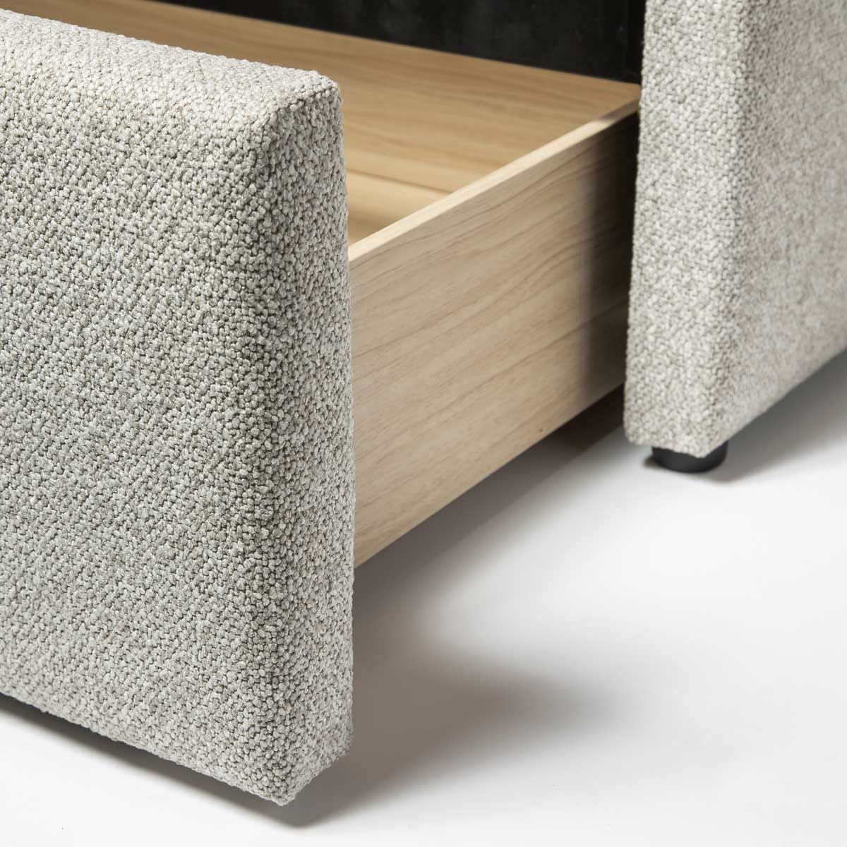 High-angle shot of the extended storage drawer showcasing the smooth pull-out functionality and neutral interior