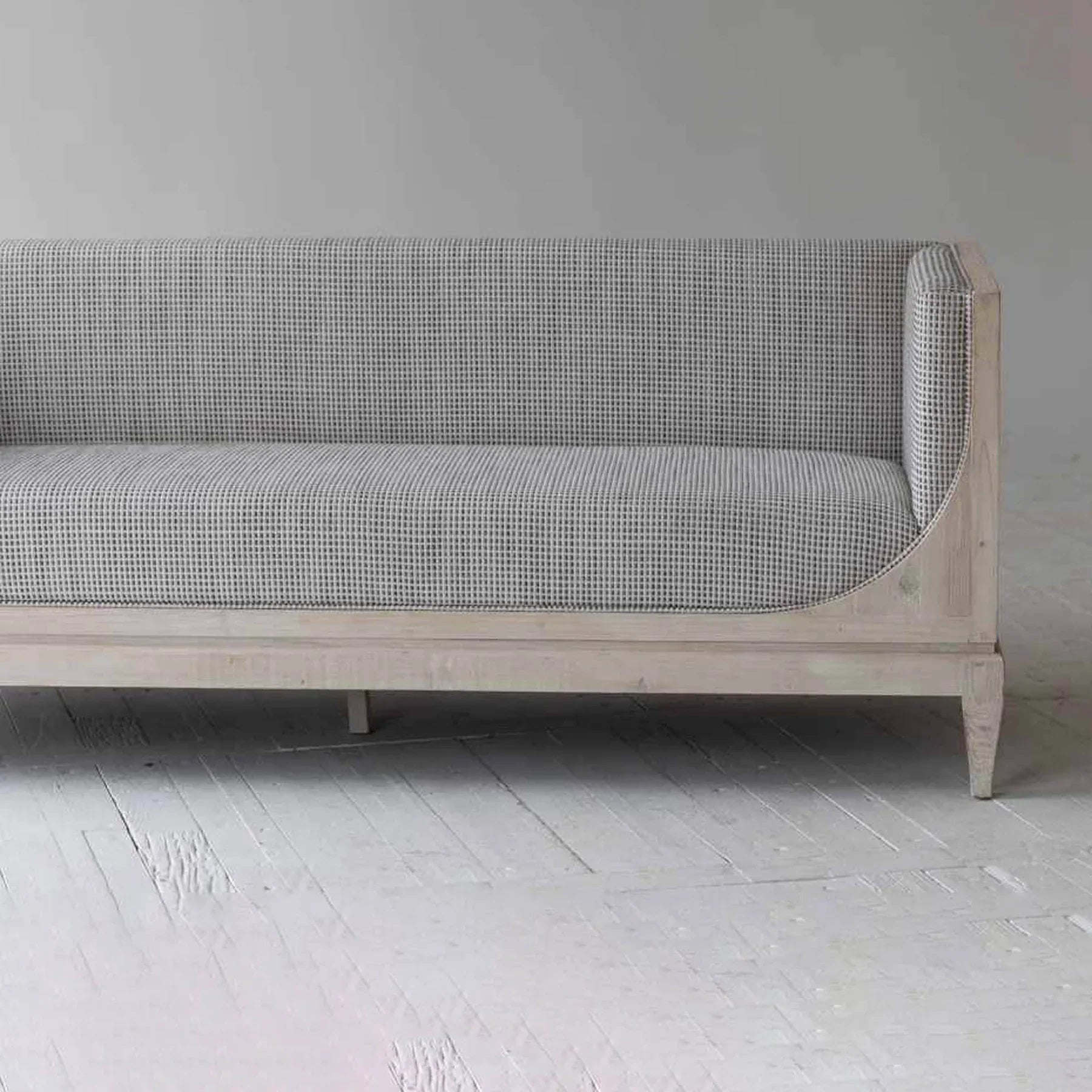 Raphael sofa front view with curved silhouette and architectural pastel design