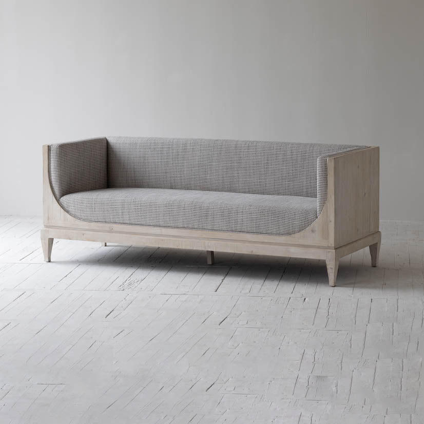 Raphael sofa front view with curved silhouette and architectural pastel design