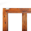 Close-up shot focusing on the "Reclaimed Pine" authenticity stamp on the wood frame