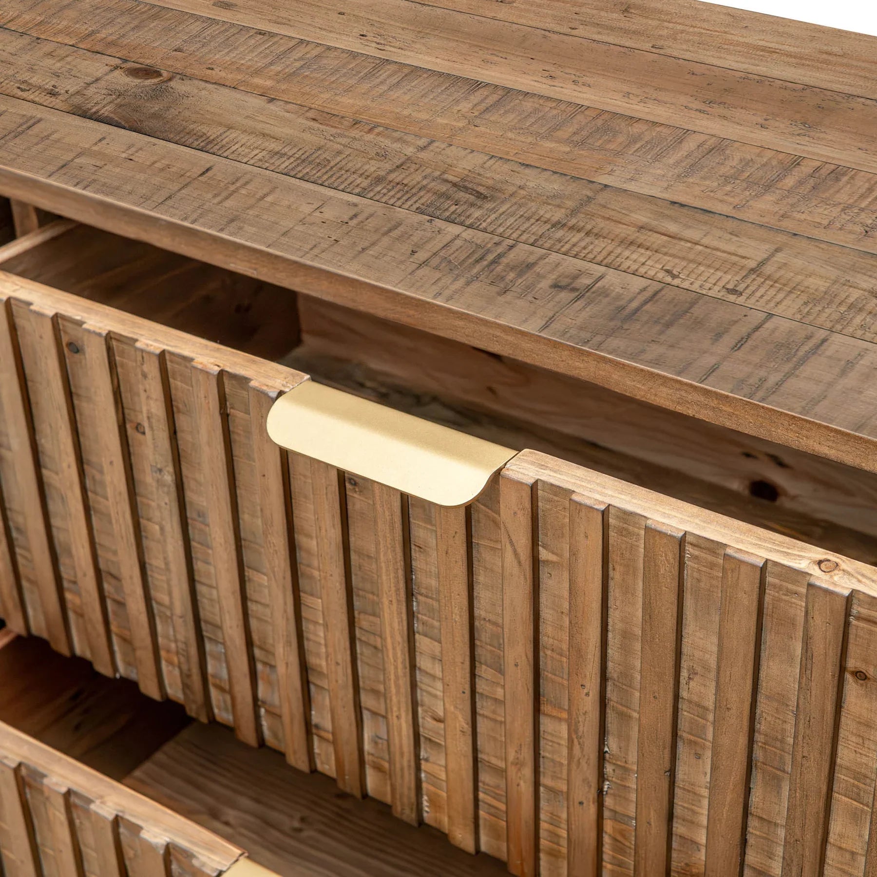 Front view of the Britanica double dresser featuring a warm reclaimed wood finish, vertical fluted drawer fronts, and sleek horizontal gold handles
