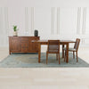 Studio lifestyle shot featuring the African Dusk extension table styled with a matching wooden sideboard and two dining chairs