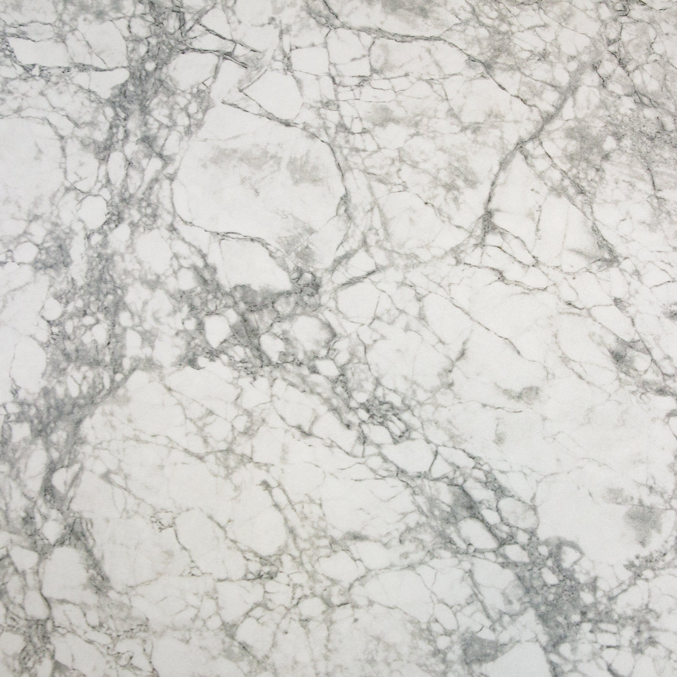 Close-up surface shot focusing on the seamless material match of the rectangular faux marble extension leaf