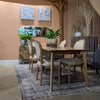 High-angle shot focusing on the expansive smooth surface of the light mango wood tabletop