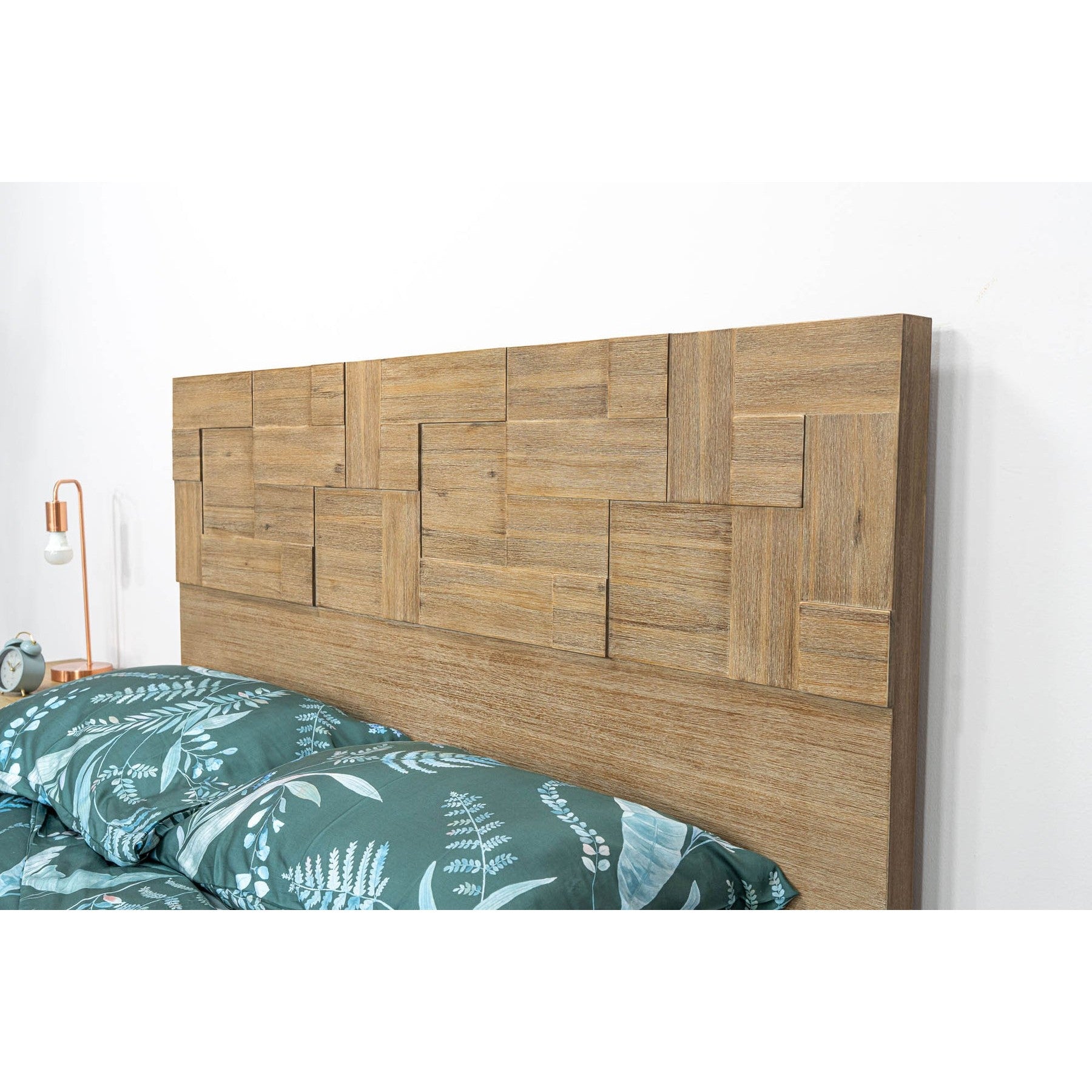 Front view of the Atlantis platform bed featuring a tall headboard with a unique patchwork wood inlay and light driftwood finish