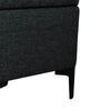 Macro view of the sleek black tapered metal leg and fabric corner joinery of the Reece storage bench