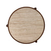 Top-down view showcasing the natural pitted texture and creamy beige tones of the circular travertine tabletop