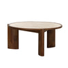 Three-quarter perspective highlighting the substantial stone surface and the organic curved profile of the dark wood legs