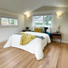 Wide-angle lifestyle shot illustrating the nightstand's placement in a naturally lit, minimalist bedroom setting
