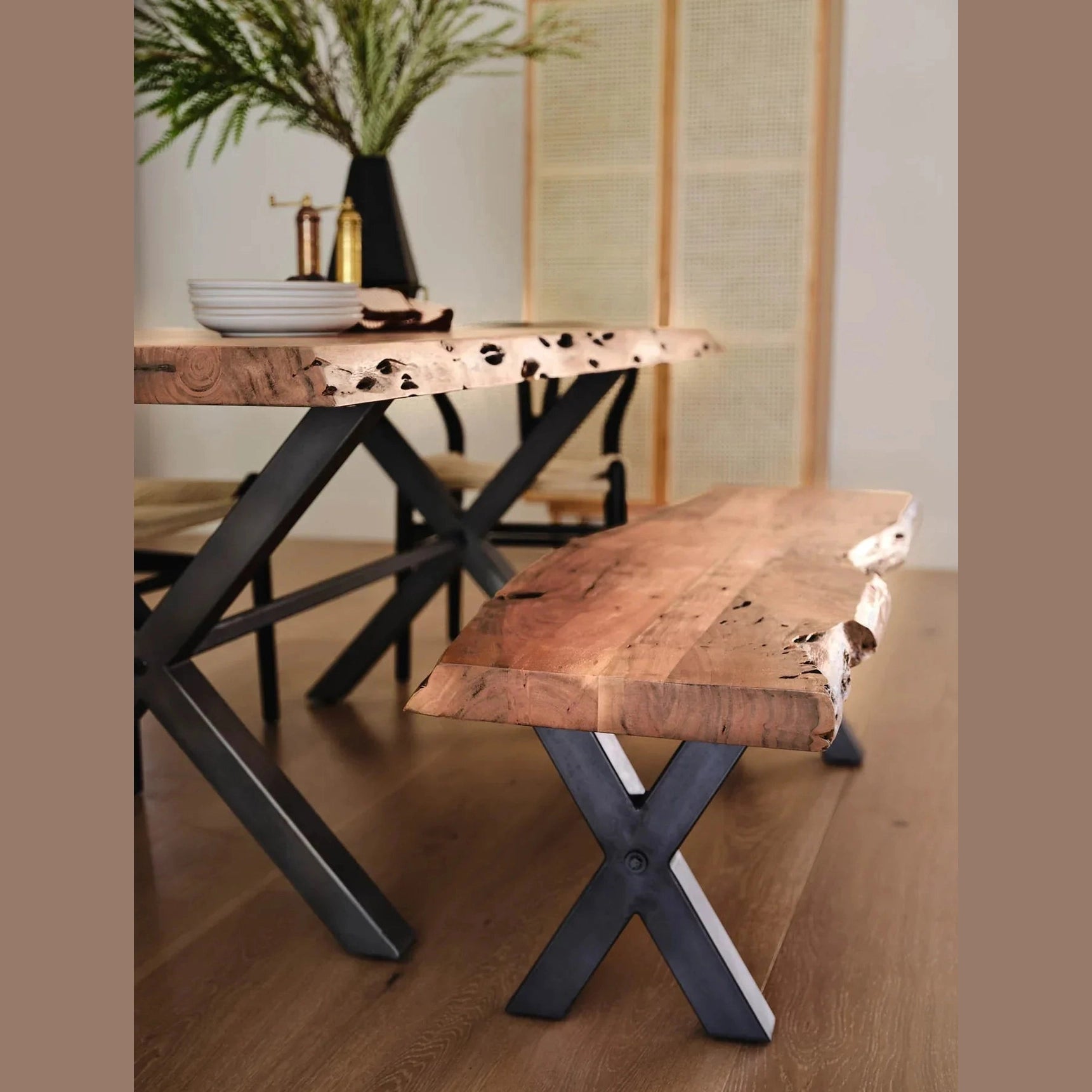 Front view of the Restore bench featuring a natural live-edge acacia wood top and black metal X-frame legs