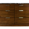 Close-up macro shot highlighting the warm walnut wood grain variations across the dresser drawer fronts