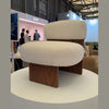 Lifestyle shot of the cream Rines chair styled in a bright modern showroom setting