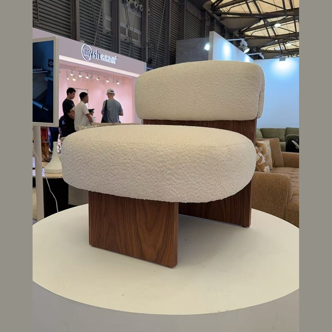 Lifestyle shot of the cream Rines chair styled in a bright modern showroom setting