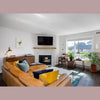 Wide perspective of the Rio chair in a luxury living room setting with a large fireplace