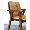 Close-up of the angular Mindi oak armrest and its clean joinery with the goat hair backrest
