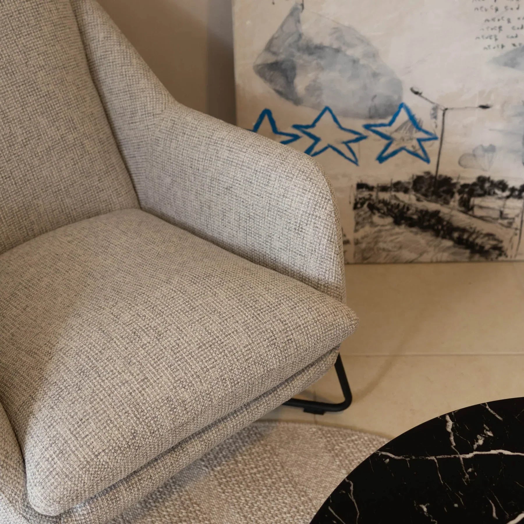 Close-up detail of light fabric upholstery on Romeo lounge chair
